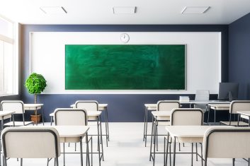 New classroom interior with empty chalkboard, furniture and daylight. Education and school concept. Mock up, 3D Rendering